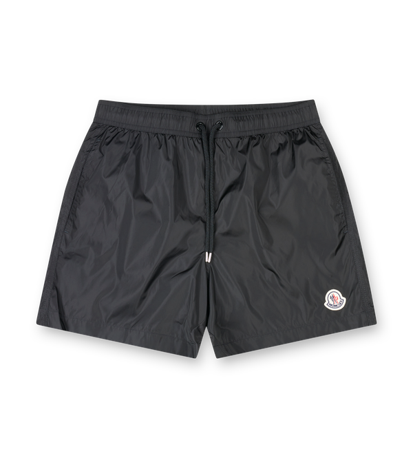 Moncler navy nylon swim shorts with drawstring waist, side pockets, zipped back pocket and silicone logo patch